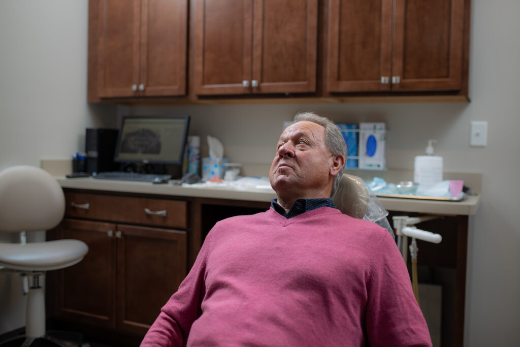 man in the chair at the oral surgeon's office discussing bone grafting