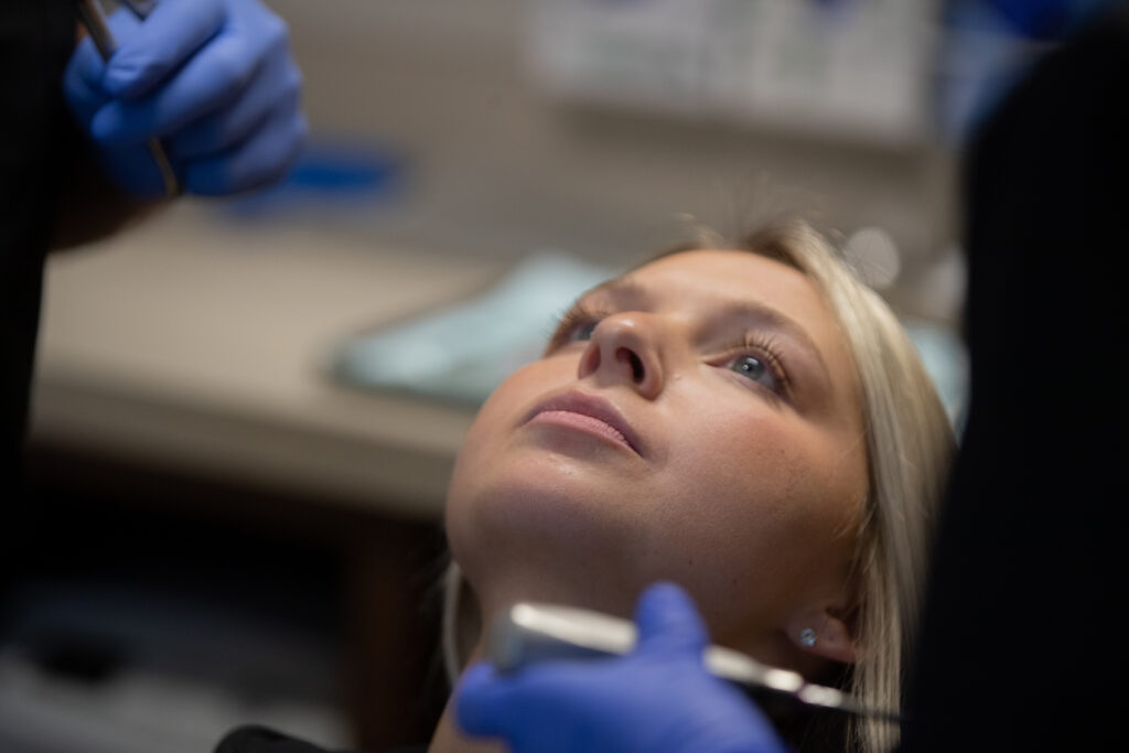 young woman laying back at the oral surgeon's