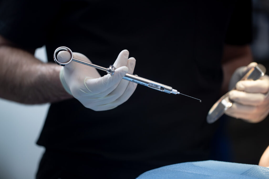 surgeon holding a syringe