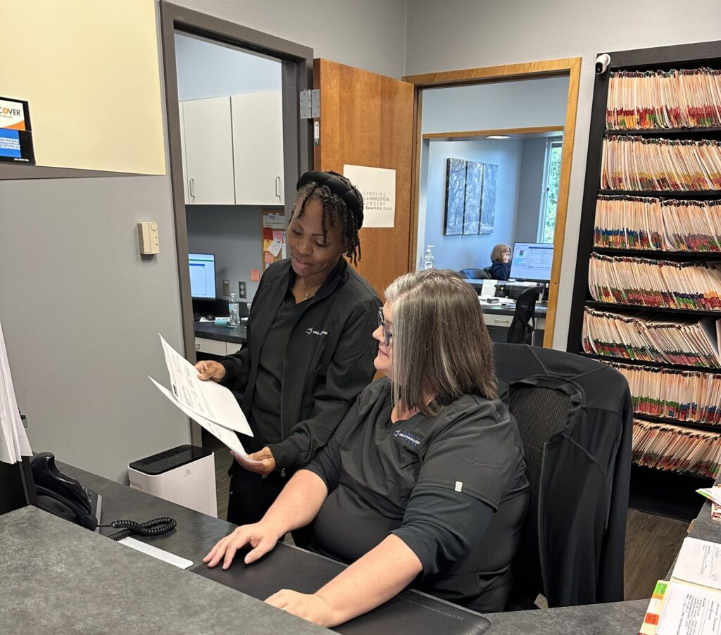 Carolina OMS team members looking at paperwork